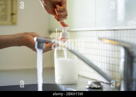 Man cleaning hands using liquid soap Stock Photo