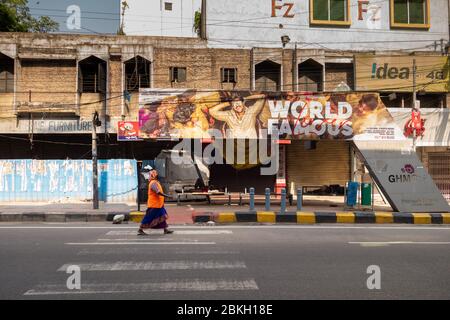 Hyderabad, India. 03 May, 2020. A sanitation worker walks past a zebra crossing in Hyderabad city,during government imposed nationwide lockdown in wak Stock Photo