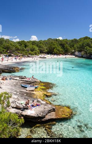 Tourists at the beach at Cala en Turqueta, Menorca, Spain Stock Photo