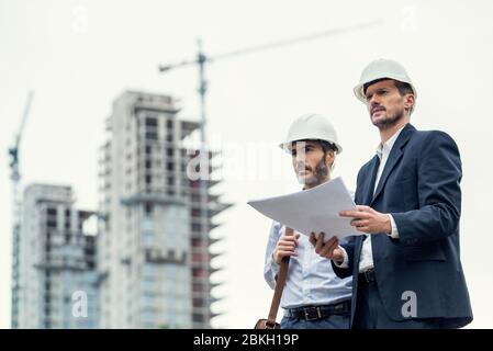 Male architects working at construction site Stock Photo