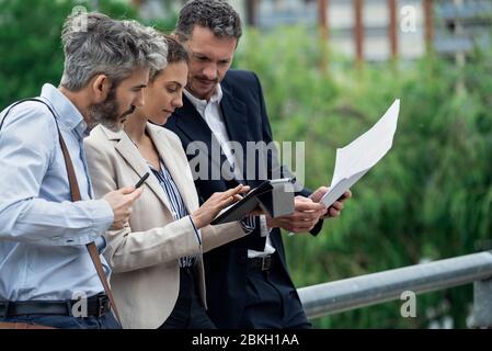 Architects using digital tablet outdoors Stock Photo