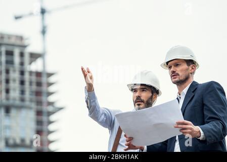 Male architects working at construction site Stock Photo