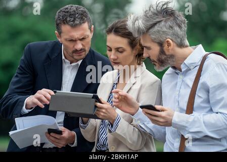 Architects using digital tablet outdoors Stock Photo