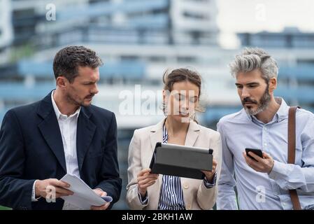 Architects using digital tablet outdoors Stock Photo