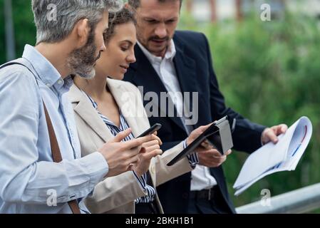 Architects using digital tablet outdoors Stock Photo