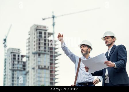 Male architects working at construction site Stock Photo