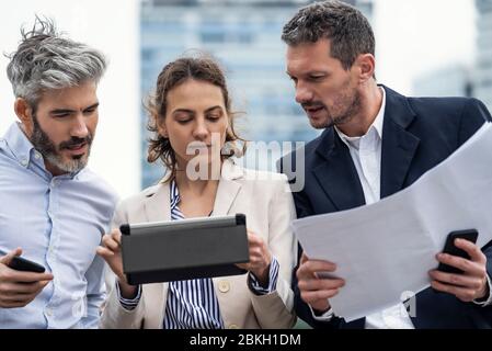 Architects using digital tablet outdoors Stock Photo