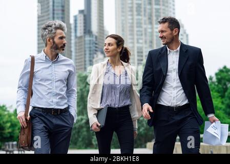Architects talking with each other in public park Stock Photo