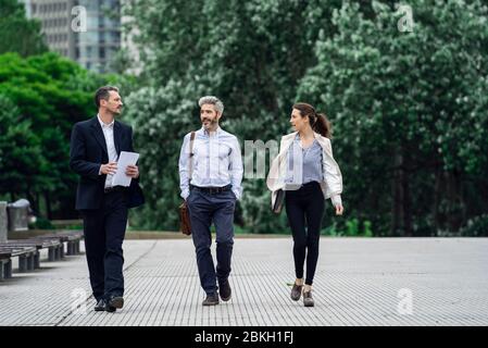 Architects talking with each other in public park Stock Photo