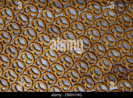 Dry mini salted pretzels as background. Top view. Stock Photo