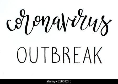 Black handwritten inscription CORONAVIRUS OUTBREAK on a white  background Stock Photo