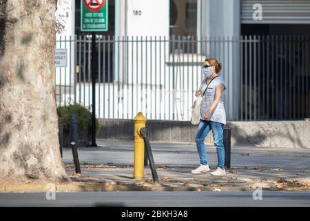 One pregnant woman worried and walking in Providencia streets during coronavirus disease infection COVID-19 with distance and mask protection Stock Photo