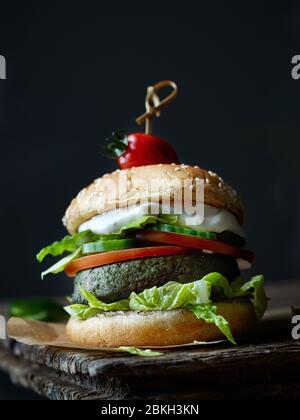 fresh tasty meat free burger on old dark wooden table Stock Photo
