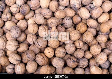 Stack of walnuts in close up at the grteengrocer Stock Photo