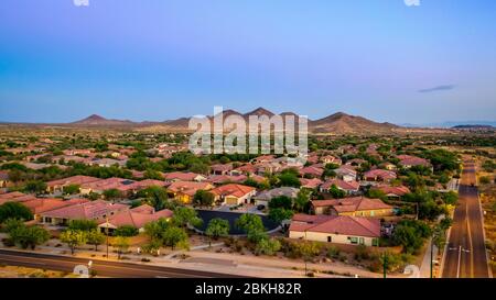 Aerial view of a desert community in Arizona during the golden hour at sunset. Stock Photo