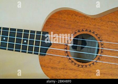 Detail of a professional quality Ukelele, or Ukulele, a musical instrument first developed by the Hawaiians in the 1800s. Stock Photo