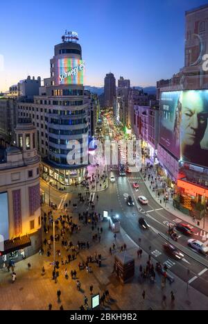 Looking along the Gran Via towards the Torre de Madrid in the distance,  with The Carrion building (center)  and the Plaza de Callao in the foreground Stock Photo