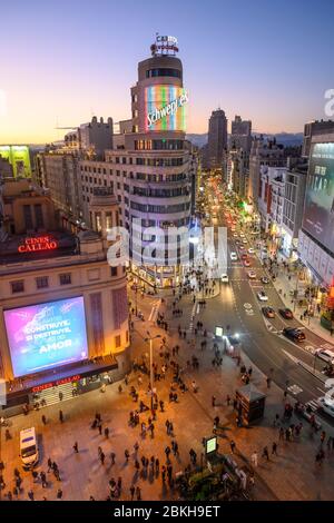 Looking along the Gran Via towards the Torre de Madrid in the distance,  with The Carrion building (center)  and the Plaza de Callao in the foreground Stock Photo