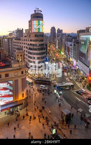 Looking along the Gran Via towards the Torre de Madrid in the distance,  with The Carrion building (center)  and the Plaza de Callao in the foreground Stock Photo