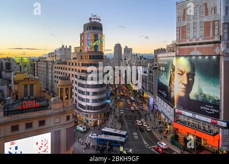 Looking along the Gran Via towards the Torre de Madrid in the distance,  with The Carrion building (center)  and the Plaza de Callao in the foreground Stock Photo