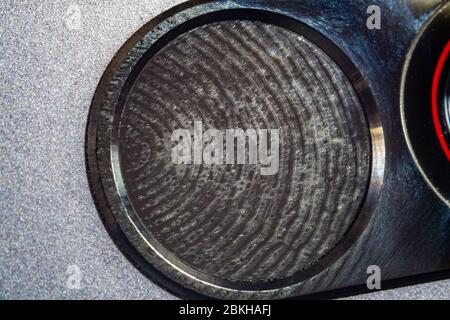 Extreme macro shot of a mobile phone fingerprint reader with a greasy fingerprint on it Stock Photo