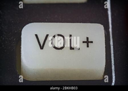 Extreme macro shot of volume button on a TV remote Stock Photo