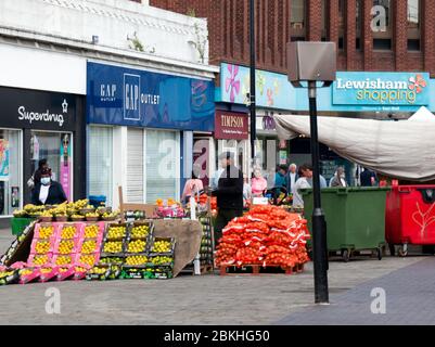 Fruit and Veg Stalls in Lewisham Market are still allowed to operate under COVID-19 Lockdown conditions  because they are classified as an essential food supply services by the UK Government. Stock Photo