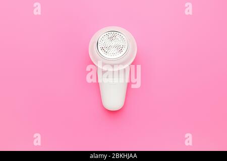 Modern fabric shaver on color background Stock Photo