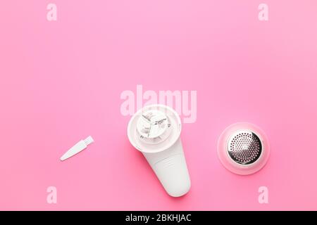 Modern fabric shaver on color background Stock Photo