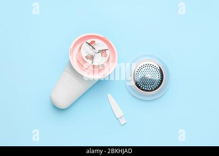 Modern fabric shaver on color background Stock Photo