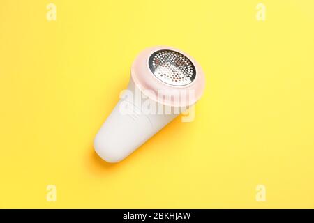 Modern fabric shaver on color background Stock Photo