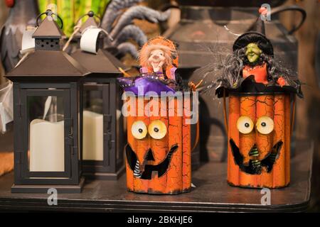Colorful Halloween decorations on a display. Jack O' lanterns and retro lanterns against a blurry background. Stock Photo