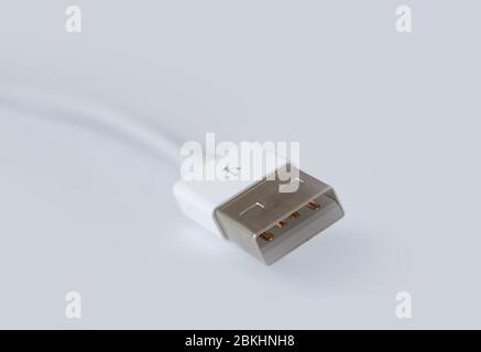 Macro photo of white micro usb plug with cord, cable and connector. Shallow depth of field on white background with copy space. Stock Photo