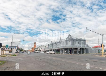 HARRISMITH, SOUTH AFRICA - MARCH 16, 2020:  A street scene, with businesses and vehicles, in Harrismith. The town hall is visible Stock Photo