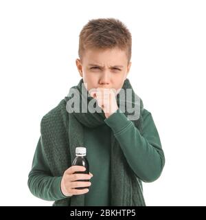 Ill little boy with cough syrup in bottle on white background Stock Photo