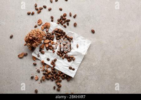 Overhead view of Pine nuts on gray surface Stock Photo