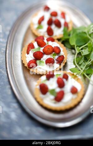 Wild strawberry whipped cream tarts Stock Photo