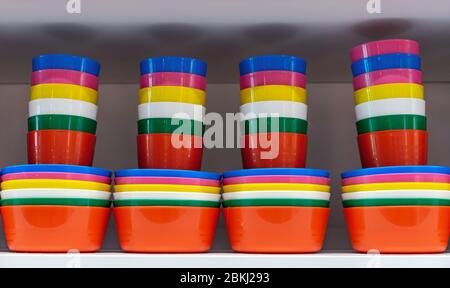 Multi-colored plastic glasses and plates for a picnic in nature. Stock Photo