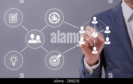 Unrecognizable entrepreneur touching white icons on interactive screen Stock Photo