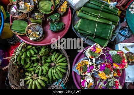 Bali island style incense, green bananas and flower basket in Ubud Morning Market Stock Photo