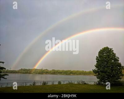 Munich, Bavaria, Germany. 4th May, 2020. In the Lake Langwied (Langwiedersee) area of Munich, Germany a double rainbow forms during changing, turbulent weather which included periods of heavy rains. Credit: Sachelle Babbar/ZUMA Wire/Alamy Live News Stock Photo