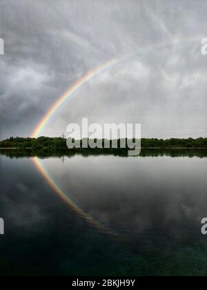 Munich, Bavaria, Germany. 4th May, 2020. In the Lake Langwied (Langwiedersee) area of Munich, Germany a double rainbow forms during changing, turbulent weather which included periods of heavy rains. Credit: Sachelle Babbar/ZUMA Wire/Alamy Live News Stock Photo