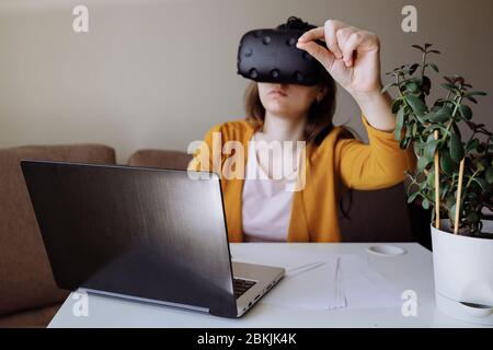 The girl communicates with friends using augmented reality. In focus is the hand that makes the OK gesture.  Stock Photo
