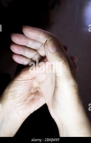 Hands of elderly woman doing a selfmassage. Manual physiotherapy Stock Photo