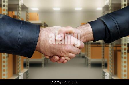 Two men shake hands confirmation of the transaction. Stock Photo