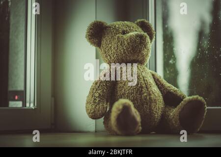 Close Up Of Teddy Bear Toy Placed By Window In Bedroom. Stock Photo