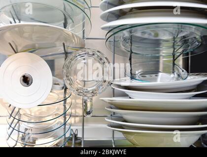 Top view of cleaned plates and different dishes in dishwasher rack. Stock Photo