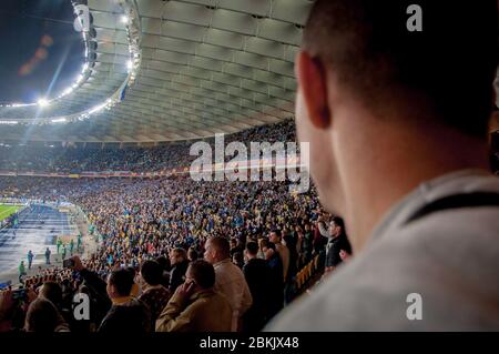 KYIV, UKRAINE - MAY 14, 2015 Football fan looking at stadium during UEFA Europa League semifinal game at NSK Olimpiyskyi stadium Stock Photo