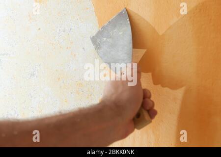 Scraping old plaster and applying new. Reconstruction of a new house. Stock Photo