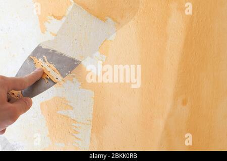 Scraping old plaster and applying new. Reconstruction of a new house. Stock Photo